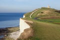 Lighthouse on a green hill overlooking the sea