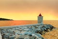 Lighthouse in the harbor of a small town Postira shot at sunset - Croatia, island Brac Royalty Free Stock Photo