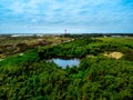 Lighthouse on the Island Amrum in Northern Germany surrounded by green area and lush trees Royalty Free Stock Photo