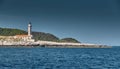 The lighthouse on the island in Croatia nearby Vis at sunset, a rocky coast, ladder to a beacon, a small cape Royalty Free Stock Photo