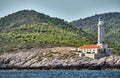 The lighthouse on the island in Croatia nearby Vis at sunset, a rocky coast, ladder to a beacon, a small cape Royalty Free Stock Photo