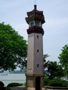 A lighthouse with lake and blue sky background Royalty Free Stock Photo