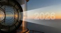 Lighthouse lens casting radiant 2026 year beam at sunset coastline Royalty Free Stock Photo