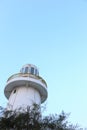 Lighthouse in light blue sky background