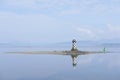 Lighthouse low tide on island blue sky water peaceful calm ocean sea black white port glasgow greenock Inverclyde Scotland uk Royalty Free Stock Photo