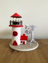 Lighthouse made of paper with trees