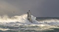 The lighthouse of the Mangiabarche shrouded by the waves of a mistral wind storm Royalty Free Stock Photo