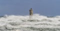 The lighthouse of the Mangiabarche shrouded by the waves of a mistral wind storm Royalty Free Stock Photo