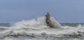 The lighthouse of the Mangiabarche shrouded by the waves of a mistral wind storm Royalty Free Stock Photo