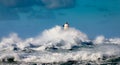 The lighthouse of the Mangiabarche shrouded by the waves of a mistral wind storm Royalty Free Stock Photo