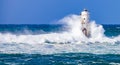 The lighthouse of the Mangiabarche shrouded by the waves of a mistral wind storm Royalty Free Stock Photo