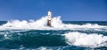 The lighthouse of the Mangiabarche shrouded by the waves of a mistral wind storm Royalty Free Stock Photo