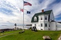 Lighthouse Marshall Point with flags in Maine Royalty Free Stock Photo