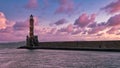 Lighthouse in the middle of a sea under a pink and blue clouded sky of Crete, Greece