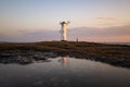 Lighthouse in the morning on the Baltic Sea with windmill wings in Swinoujscie, Poland