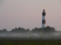 Lighthouse in the morning mist Royalty Free Stock Photo