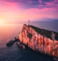 Lighthouse on the mountain peak at colorful sunset in summer Royalty Free Stock Photo