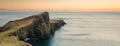 Lighthouse at Neist Point, Isle of Skye, beautiful sunset with cliffs, mountains and islands Royalty Free Stock Photo