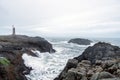 Lighthouse next to Nato base in Stokksnes peninsula next to the city of Hofn in Iceland. Waves crash ashore with overcast sky