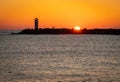 Lighthouse at the north pier Ijmuiden in The Netherlands by sunset Royalty Free Stock Photo