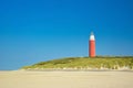 Lighthouse at beach of island Texel in Netherlands on summer day with blue sky Royalty Free Stock Photo