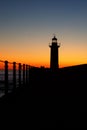 Lighthouse On The Ocean, Silhouette At Sunset