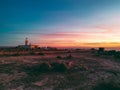 Lighthouse over the sunset sky