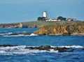 A lighthouse perched on a rocky shore.