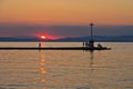 Lighthouse and pier in Limenas harbour at sunset, island of Thassos