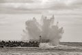 Lighthouse on the pier of Norre Vorupor in storm and heavy sea, Jutland, Denmark, sepia tinted