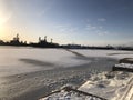 Lighthouse and pier at sunset in the city of Kronstadt in winter.