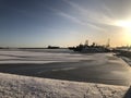 Lighthouse and pier at sunset in the city of Kronstadt in winter.