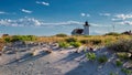 Lighthouse Point on beach dunes. Royalty Free Stock Photo