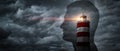 The lighthouse points the way against the background of a silhouette of a man Concept on the topic of psychology, psychiatry, self