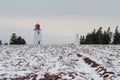 Lighthouse Beside Potato Field in Winter