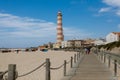 Lighthouse of Praia da Barra against the blue sky. It is the highest lighthouse in the country. View from the side of a wooden