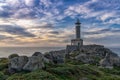 The lighthouse at Punta Nariga in warm evening light on the coast of Galicia in Spain Royalty Free Stock Photo
