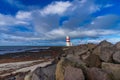 Lighthouse with red stripes wide angle with cloudscape Royalty Free Stock Photo