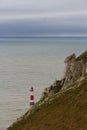 Lighthouse red and white striped on stormy winter day. Royalty Free Stock Photo