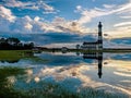 Lighthouse reflection in marshland water