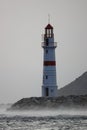 Lighthouse among the rising waves of a storm in Lodos. Turgutreis, Bodrum. Royalty Free Stock Photo