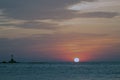 The magical colors of the sunrise - cloudy sky and the solar disk, kissing the sea. Royalty Free Stock Photo