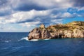 Lighthouse on the rocky Aegean shore