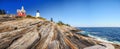 Lighthouse on a rocky high bank of the Atlantic Ocean. USA. Maine.