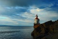 Lighthouse on a rocky point Royalty Free Stock Photo