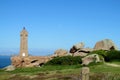 Ploumanach Mean Ruz lighthouse on the rocky seashore of pink granite coast in France Royalty Free Stock Photo