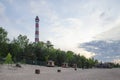 Lighthouse on the sandy beach of the lake in the evening Royalty Free Stock Photo