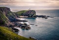 Lighthouse on a sea coastline cliff during sunset - North-West Scotland Royalty Free Stock Photo