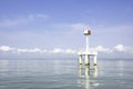 The lighthouse in the sea with eflection of water Background cloud and sky Royalty Free Stock Photo