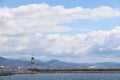 Lighthouse and sea pier in the port of Alanya against the backdrop of a mountain range, Turkey, April, 2021 Royalty Free Stock Photo